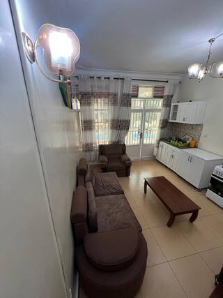 Furnished living room with open kitchen